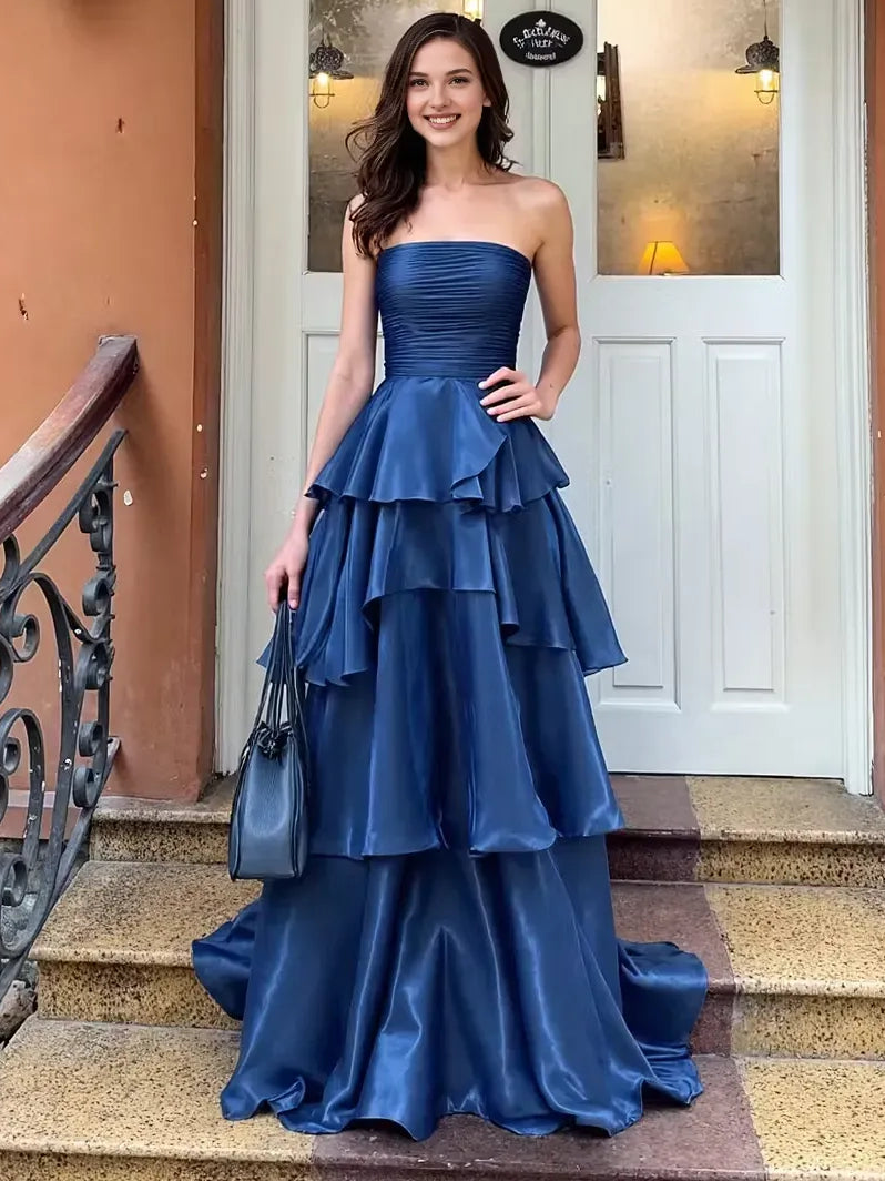 Dark navy strapless tiered prom dress with ruched bodice and layered ruffle skirt, floor length