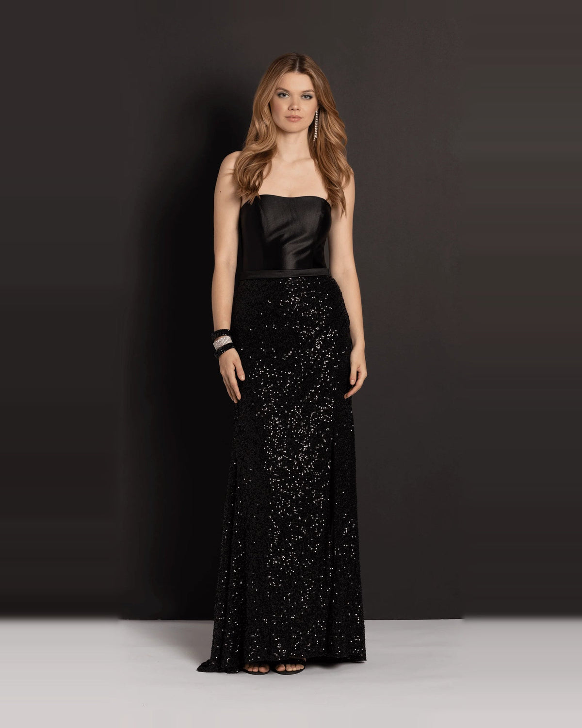 Black strapless column maxi prom dress with fitted satin bodice and sequin skirt