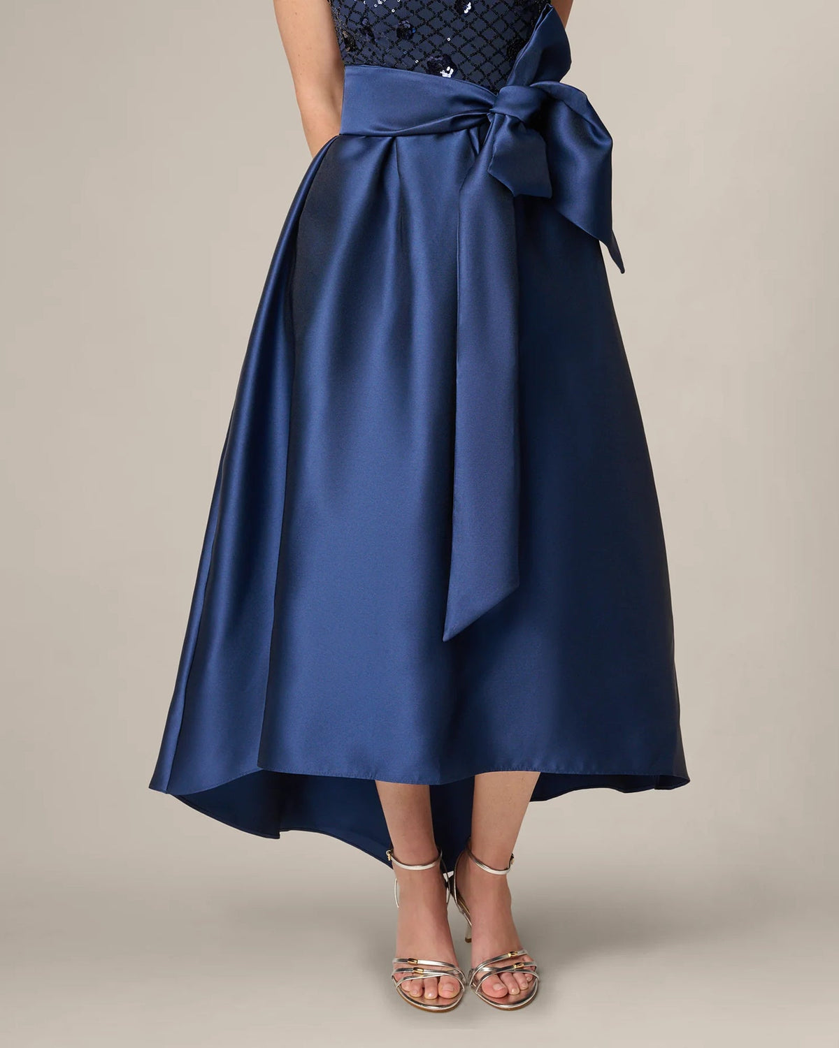 Navy A-line maxi skirt with satin bow waist and draped, tiered hem