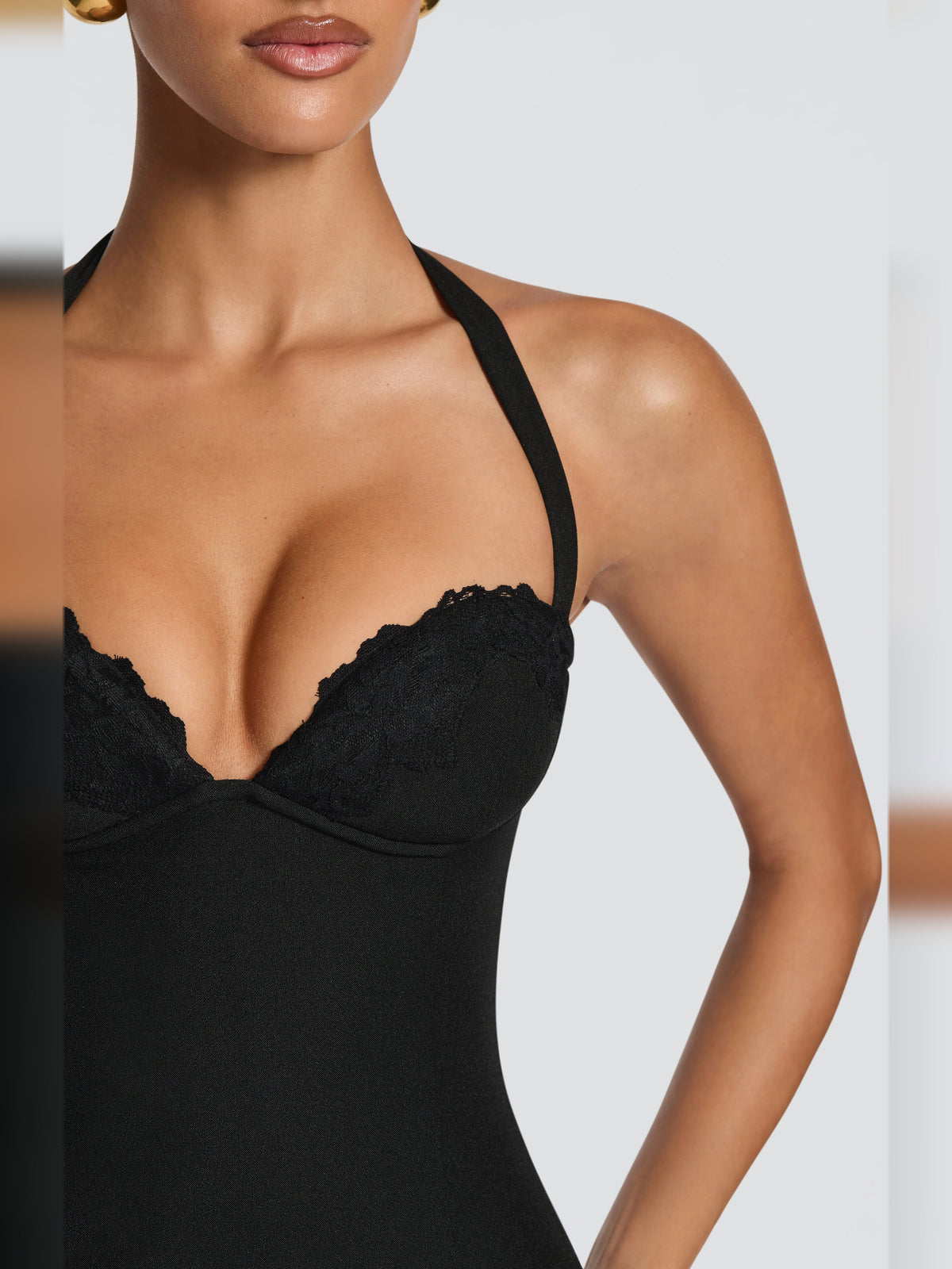 Black halter neck mini dress with scalloped lace cups and crisscross strap detail