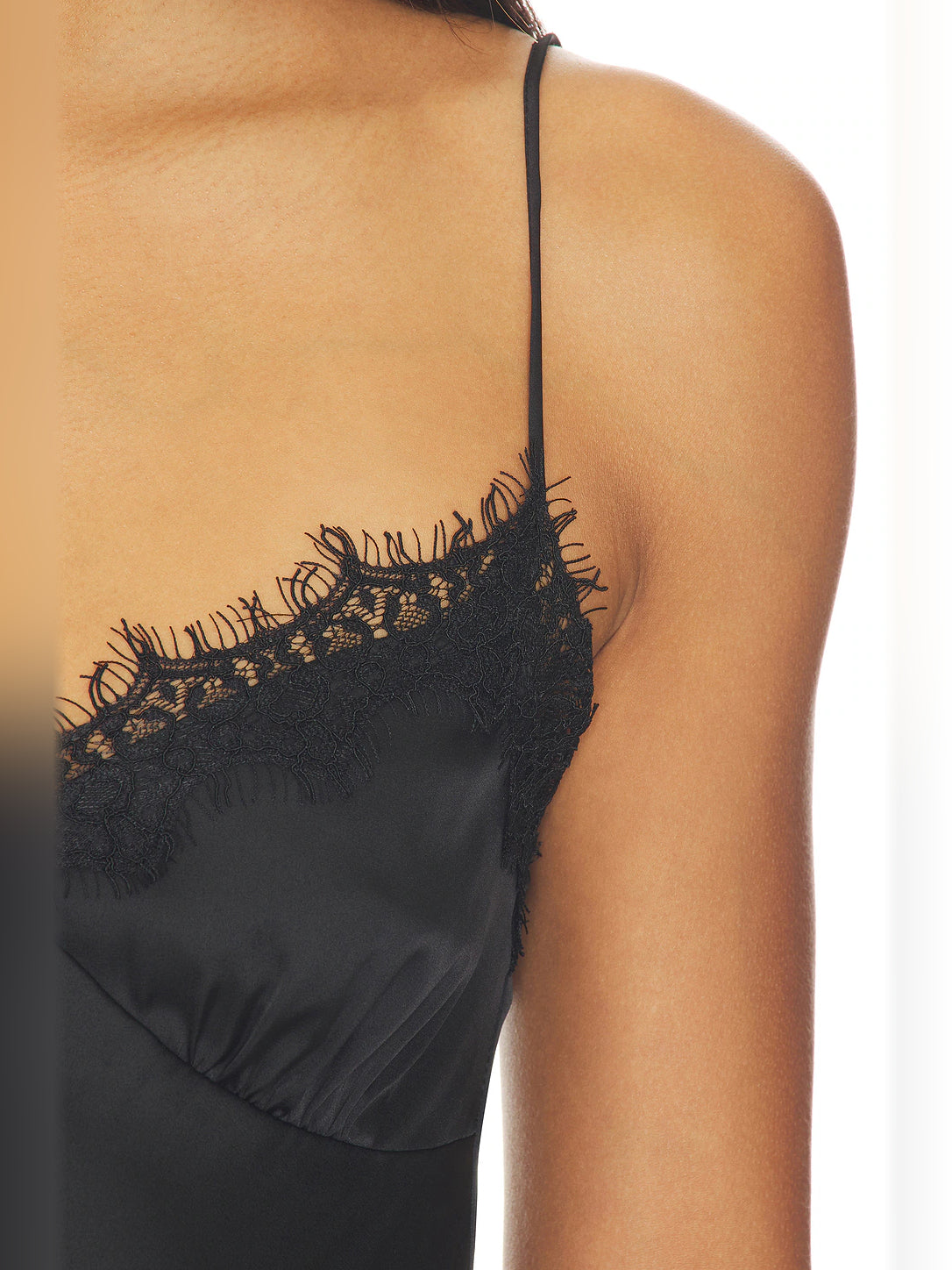 Black lace camisole neckline with scalloped trim and spaghetti strap detail