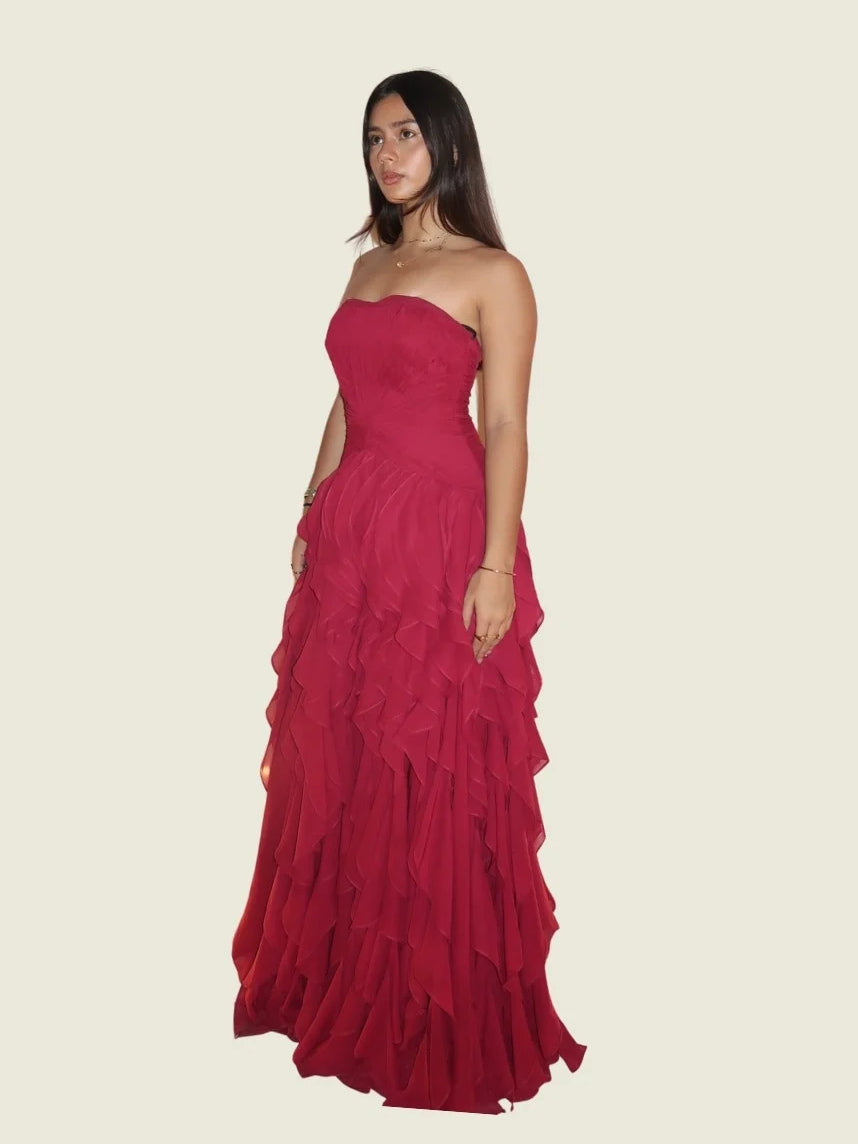 Red strapless sweetheart ball gown with ruched bodice and tiered ruffle skirt, side view