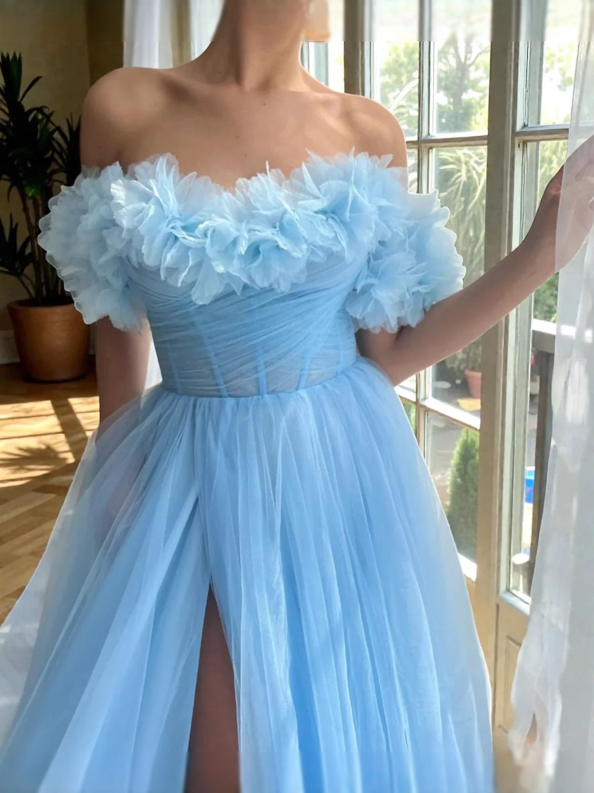 Light blue off-shoulder corset-style ball gown with ruffled sleeves and side slit