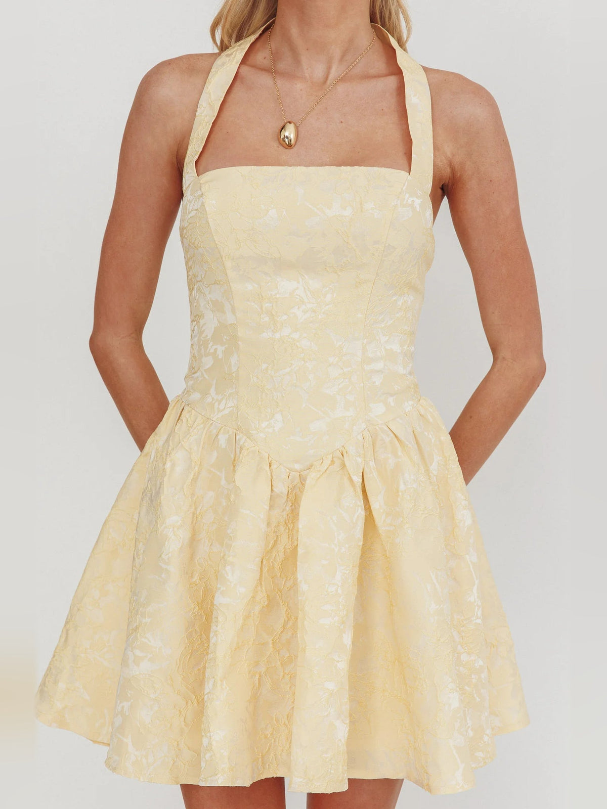 Butter halter mini dress close-up: square neckline and gathered tiered skirt