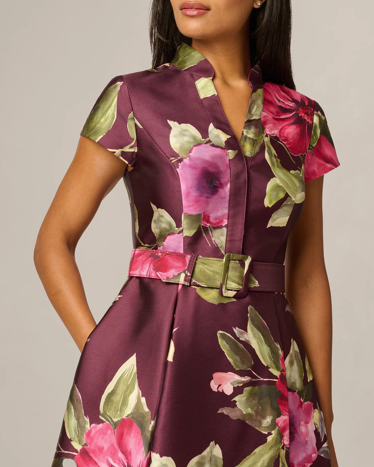 Burgundy floral midi-to-maxi dress detail: V-neck, short sleeves, gold buckle belt
