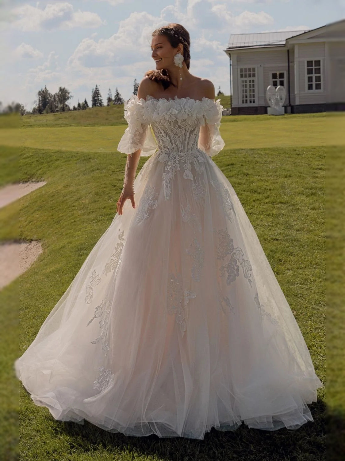 Ivory tulle wedding dress with off-shoulder sleeves, corset bodice, and full A-line skirt