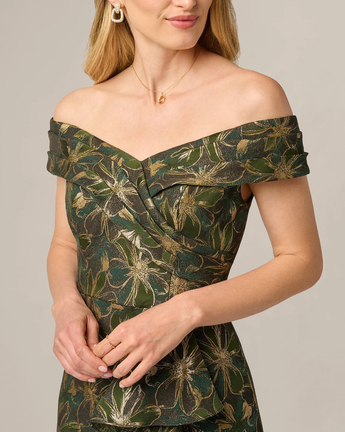 Off-shoulder neckline and corset-style seam detail on dark olive gold floral maxi dress