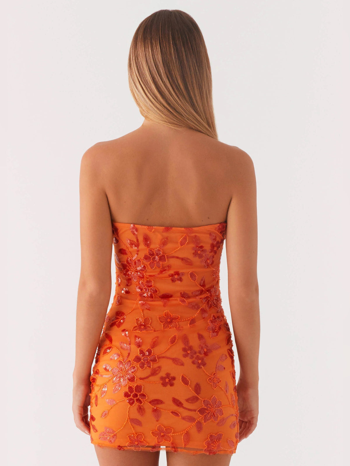Orange strapless mini dress with floral beaded/sequin detailing, open back view