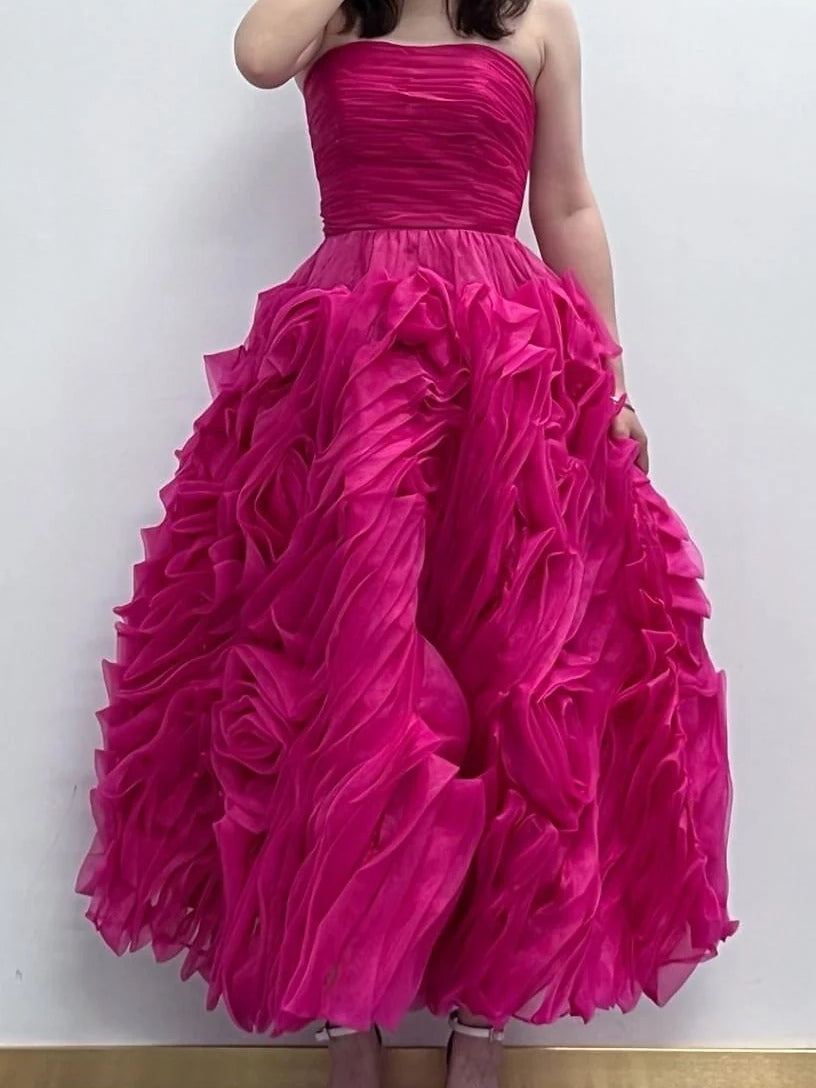 Hot pink strapless corset dress with voluminous tiered ruffle skirt, back view