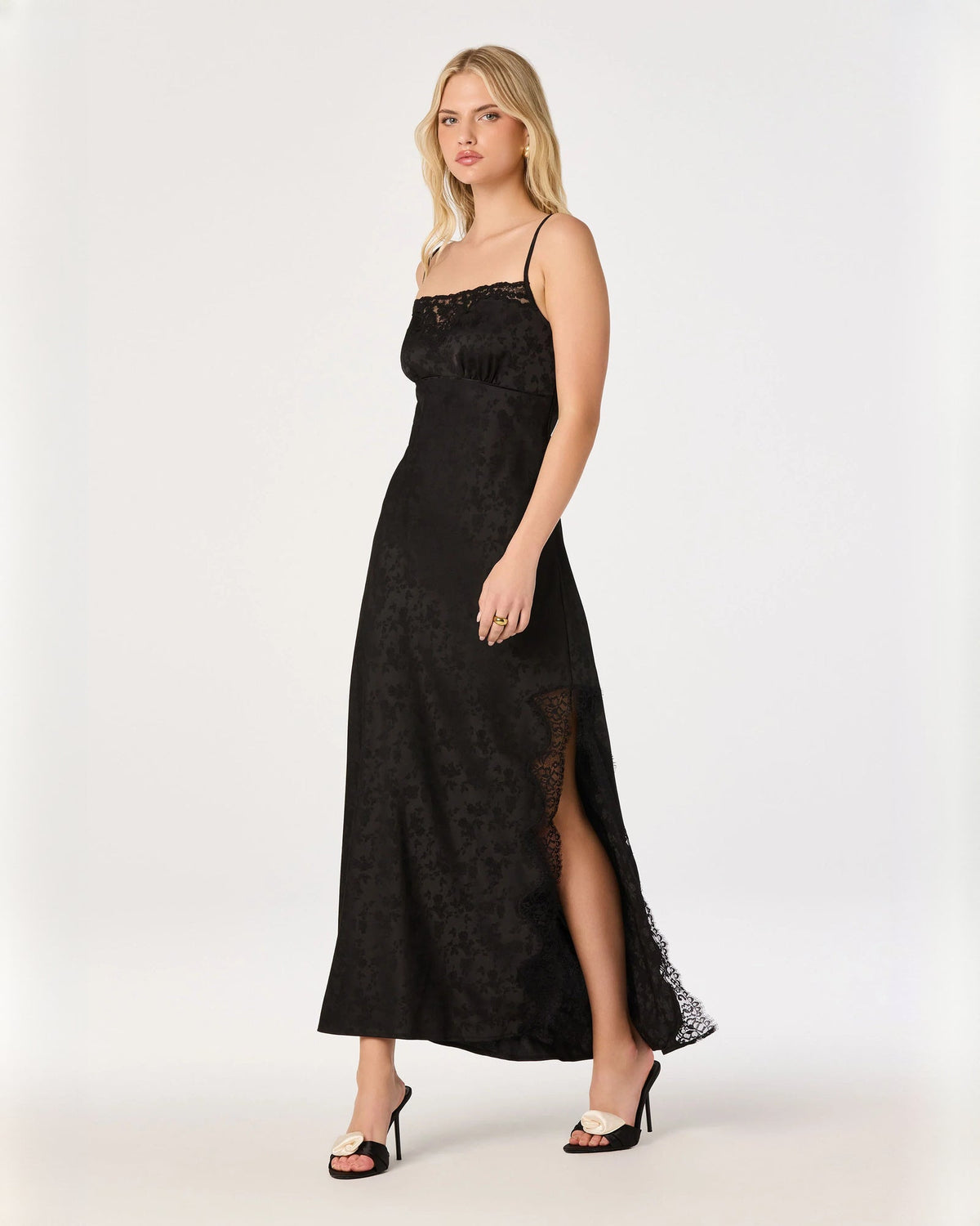 Black sleeveless maxi dress with lace bodice and scalloped sheer side slit.