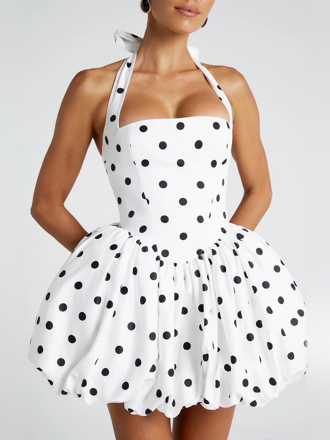 Close-up of polka-dot corset bow halter mini dress bodice and gathered fit-and-flare skirt