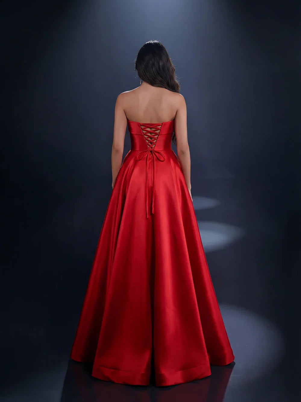 Red strapless satin formal dress with lace-up back and high slit