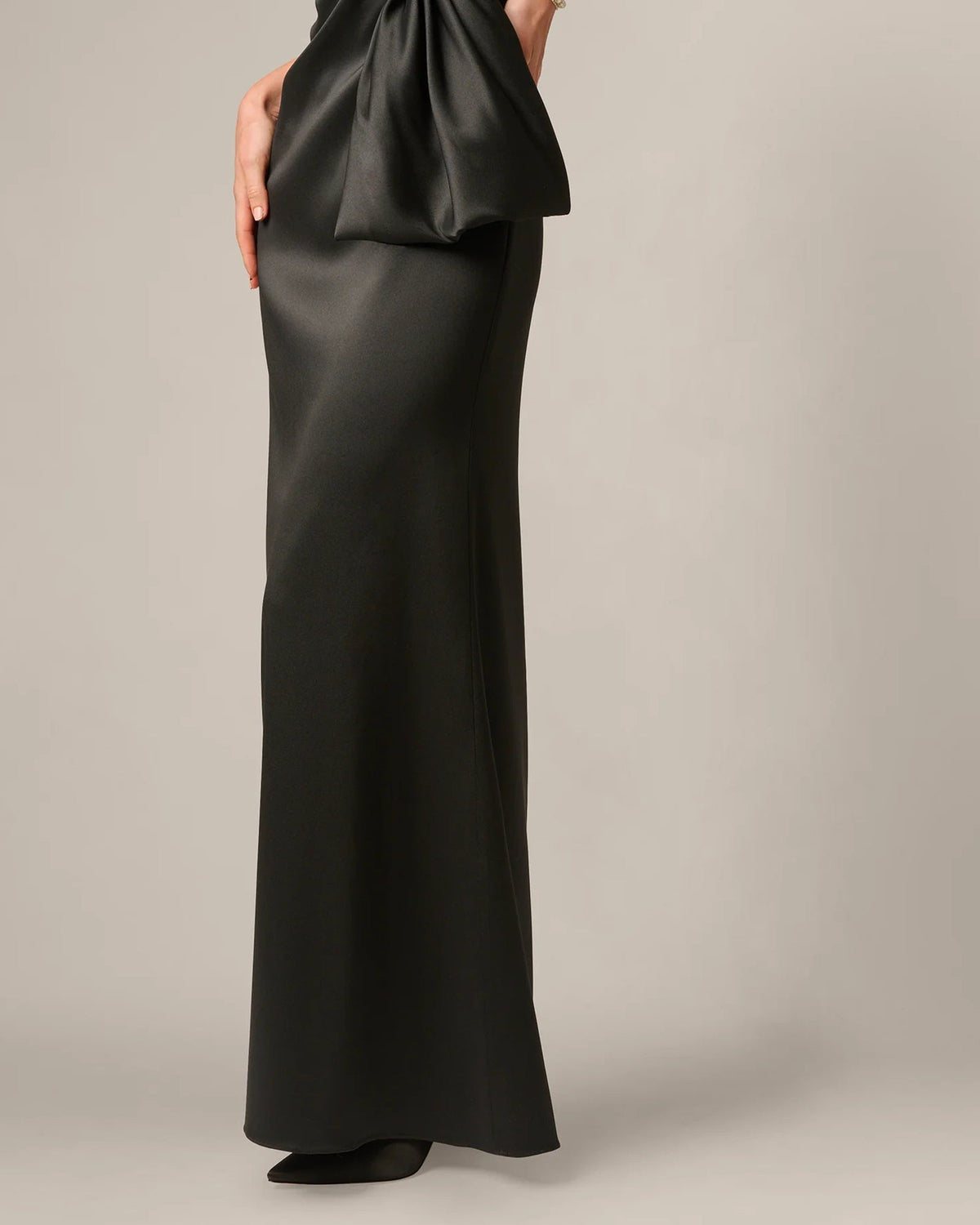 Black strapless A-line maxi skirt with draped peplum detail at the waist