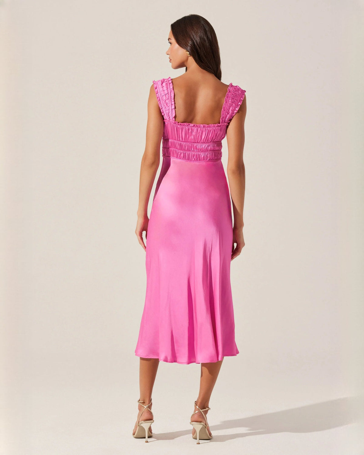 Pink satin midi dress back view with square open back and ruched panel, ruffle straps.
