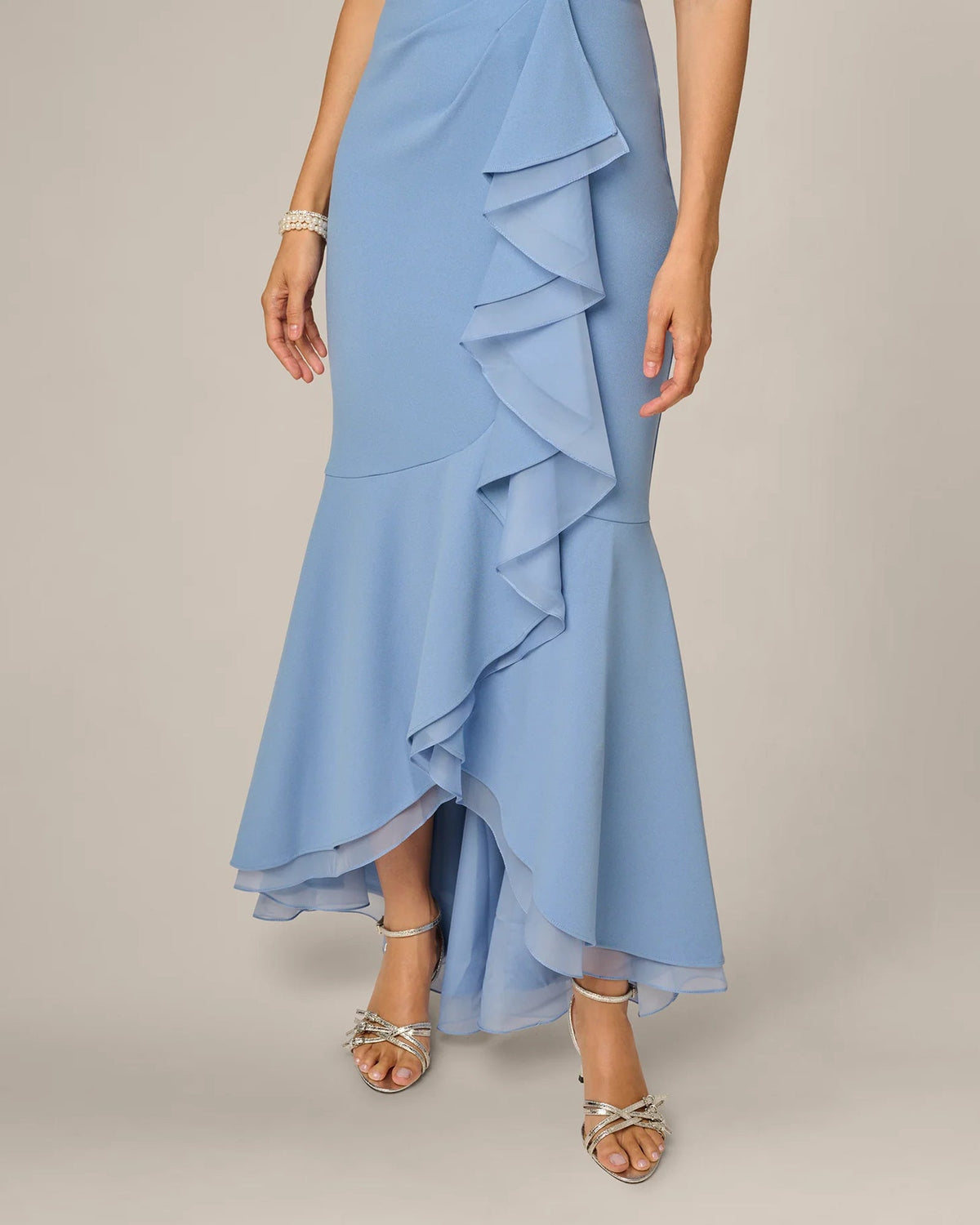 Blue A-line maxi dress with layered ruffle details and high-low skirt hem