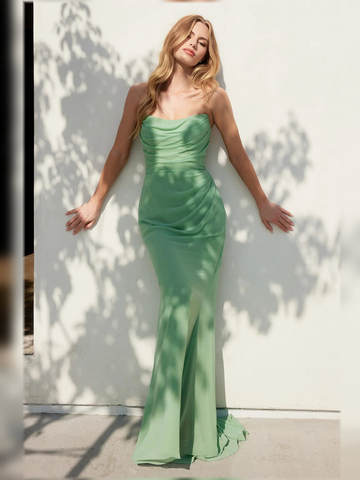 Strapless ruched formal dress in emerald green, floor-length fitted look