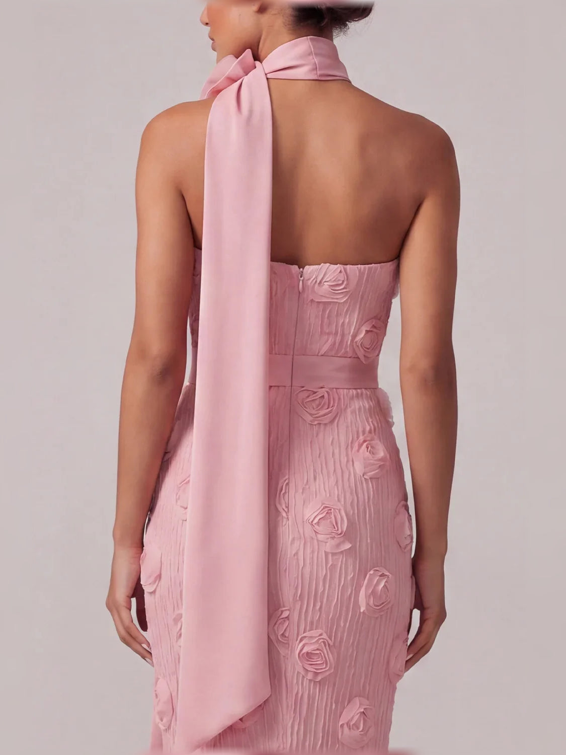 Light pink backless strapless mermaid gown with long satin ribbon bow and rose applique