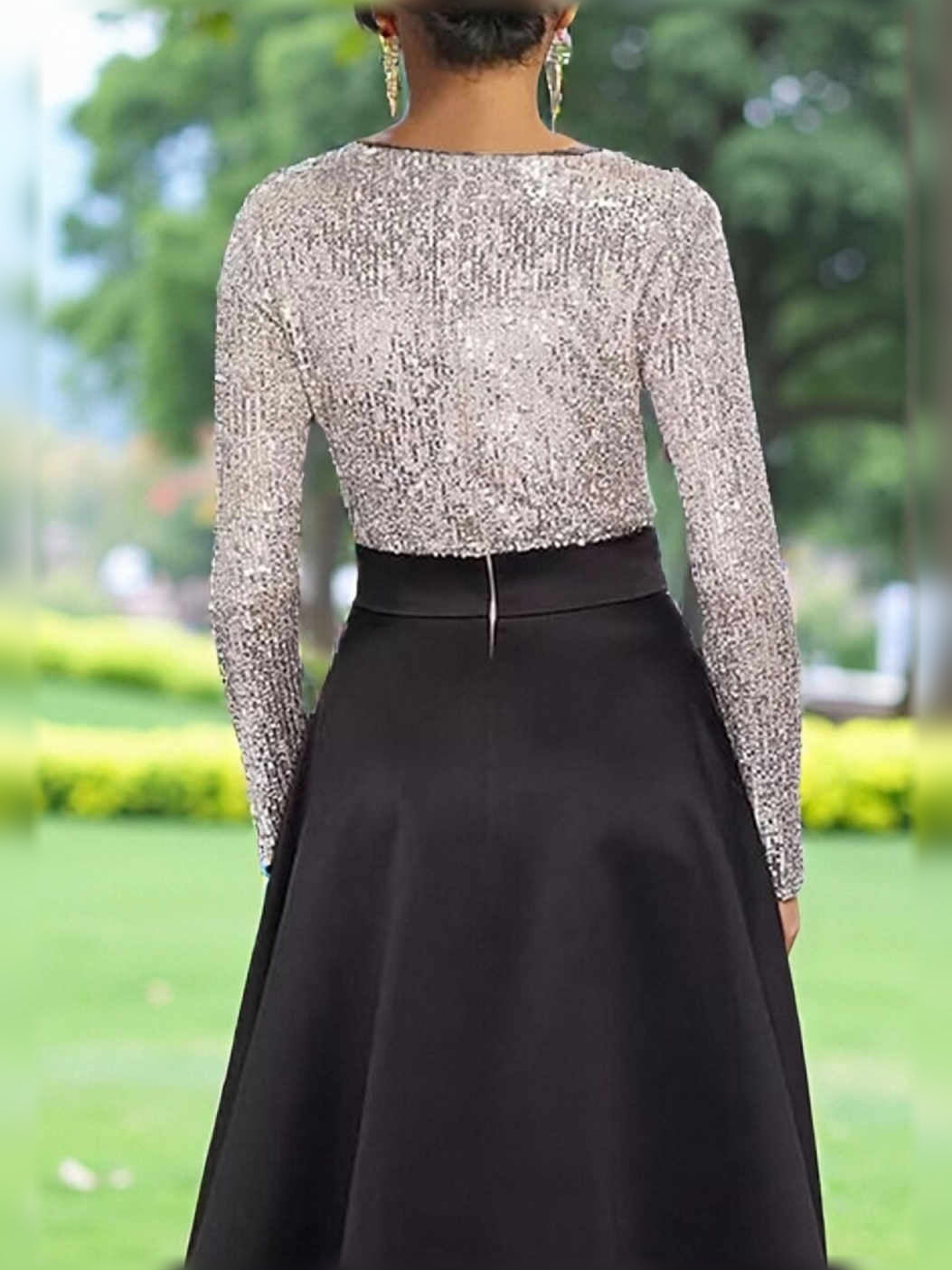 Black A-line formal dress with long-sleeve sequin bodice and satin skirt, waist bow.