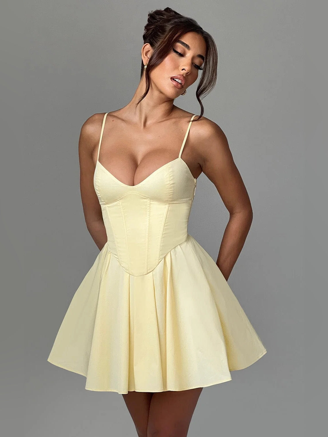Lemon mini dress with V-neck corset bodice, spaghetti straps, and pleated skirt