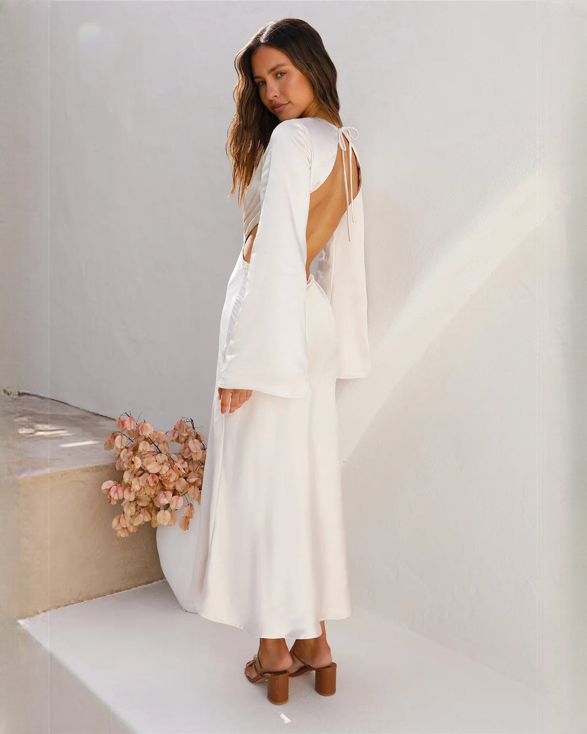 White satin maxi dress with open back and narrow halter shoulder straps