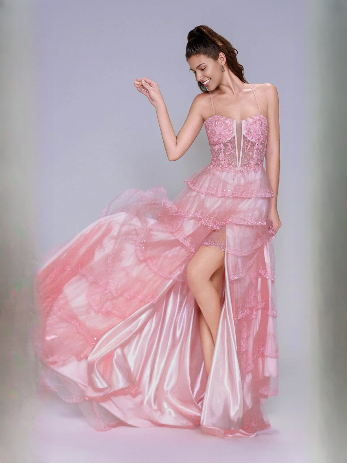 Light pink tiered ruffle formal gown with floral bodice and front slit