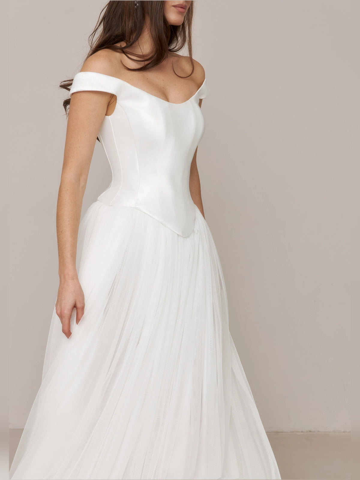 Ivory off-shoulder satin corset A-line wedding dress with layered pleated skirt