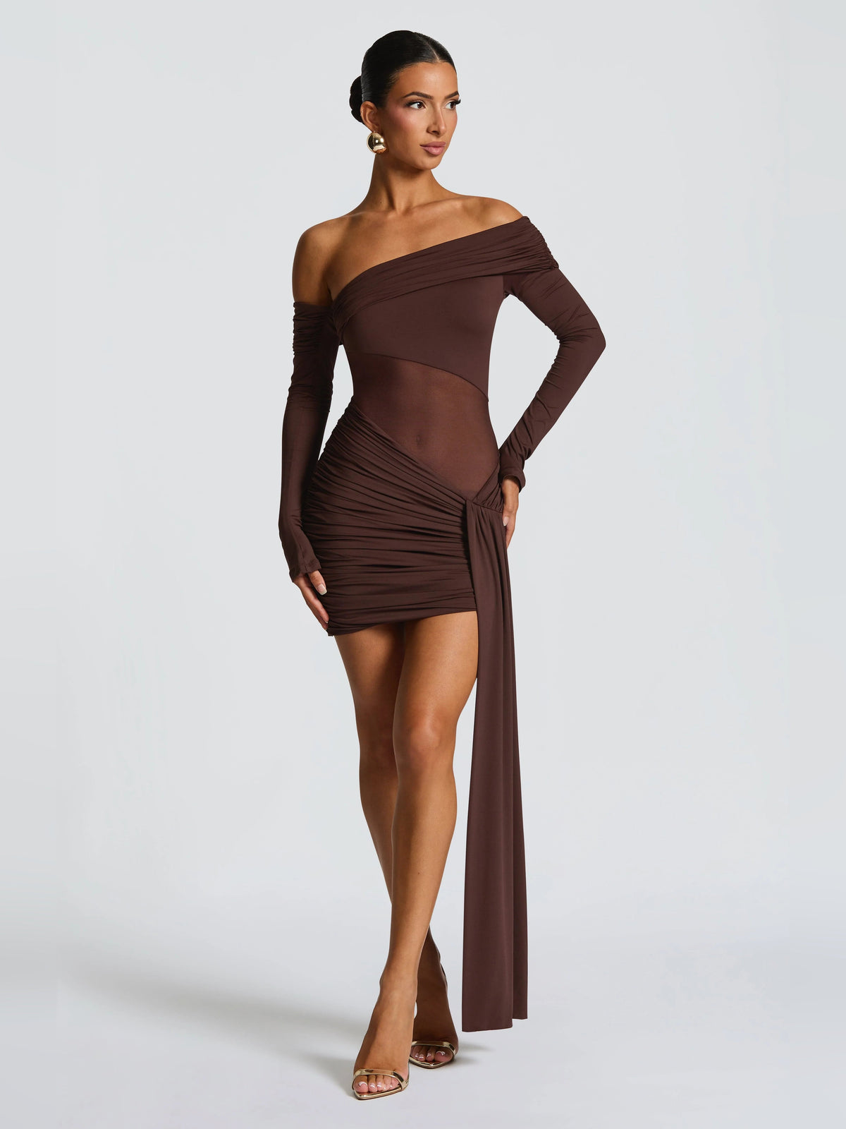 Brown off-shoulder ruched mini dress with long sleeves and trailing side drape