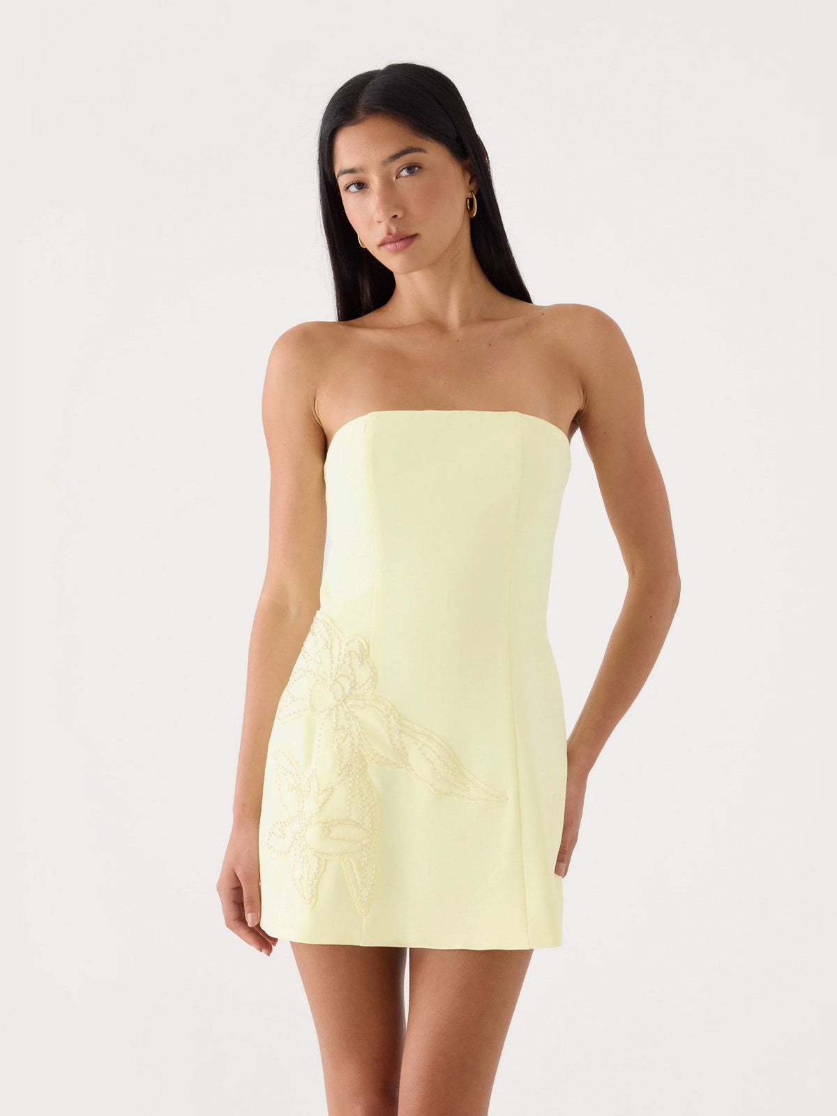 Yellow strapless mini dress with embroidered floral applique detail at the lower bodice