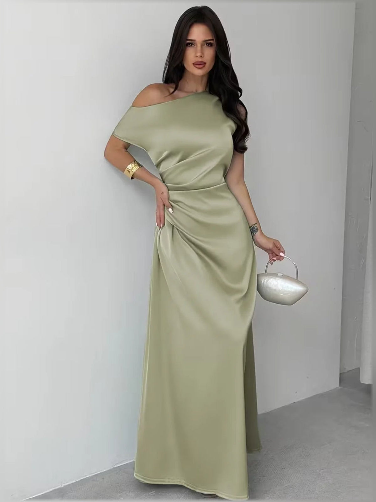 Olive green one-shoulder cutout sheath floor-length formal dress, clutch in hand