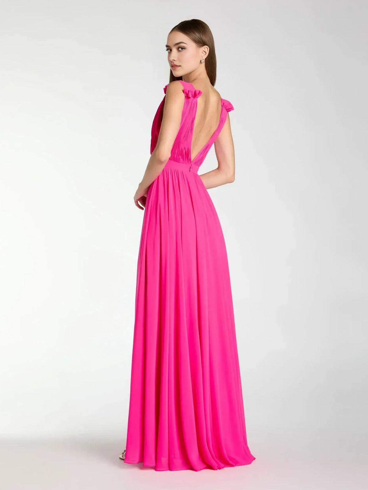 Hot pink V-neck formal dress with ruffle shoulder accents and thigh slit, maxi length