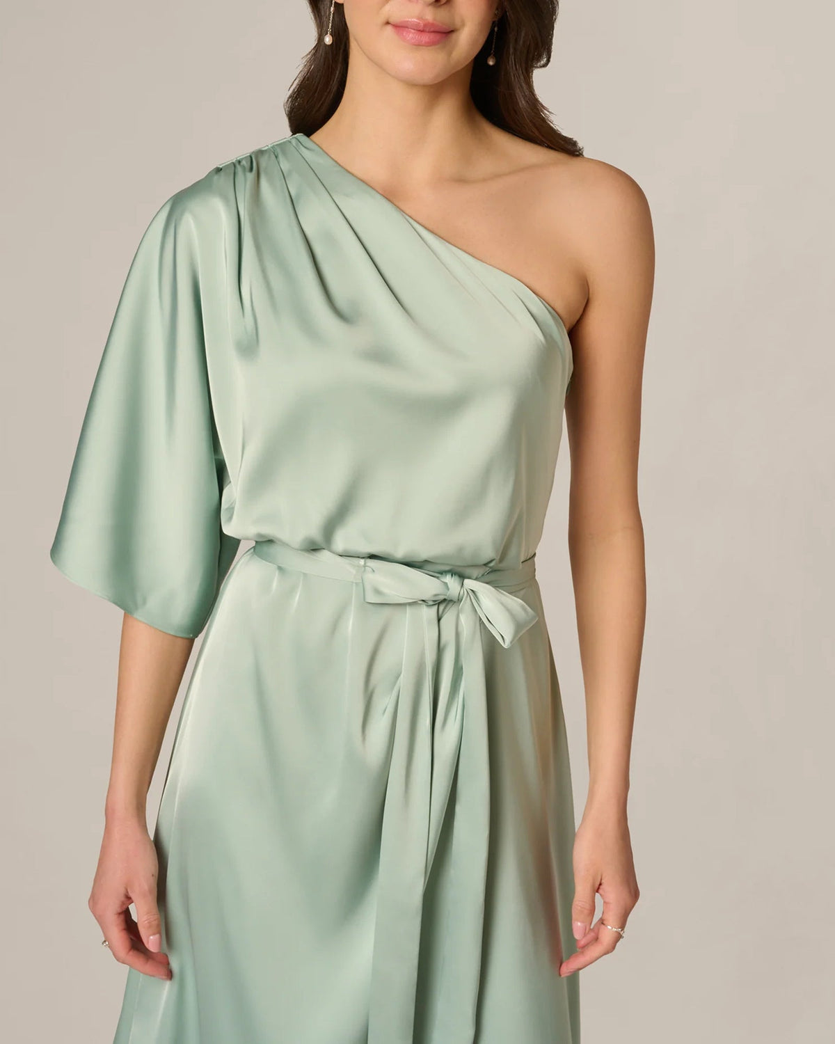 Mint green one-shoulder draped bodice with tie waist detail on midi A-line dress
