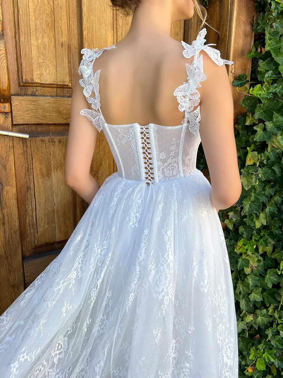 White lace corset back tea-length dress with vertical back lacing and bow spaghetti straps