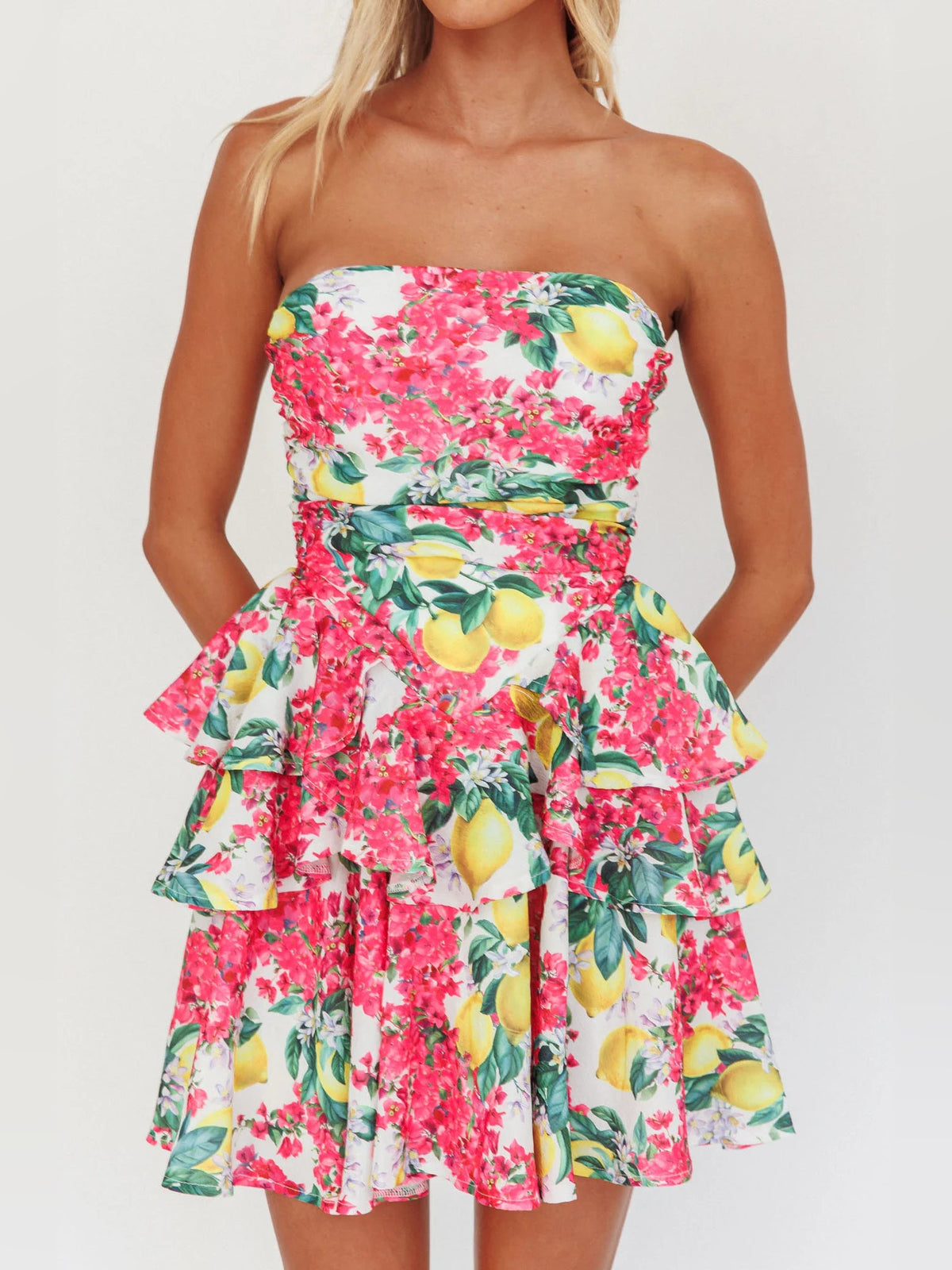 Strapless layered mini dress in pink lemon floral print with peplum-like ruffle tiers
