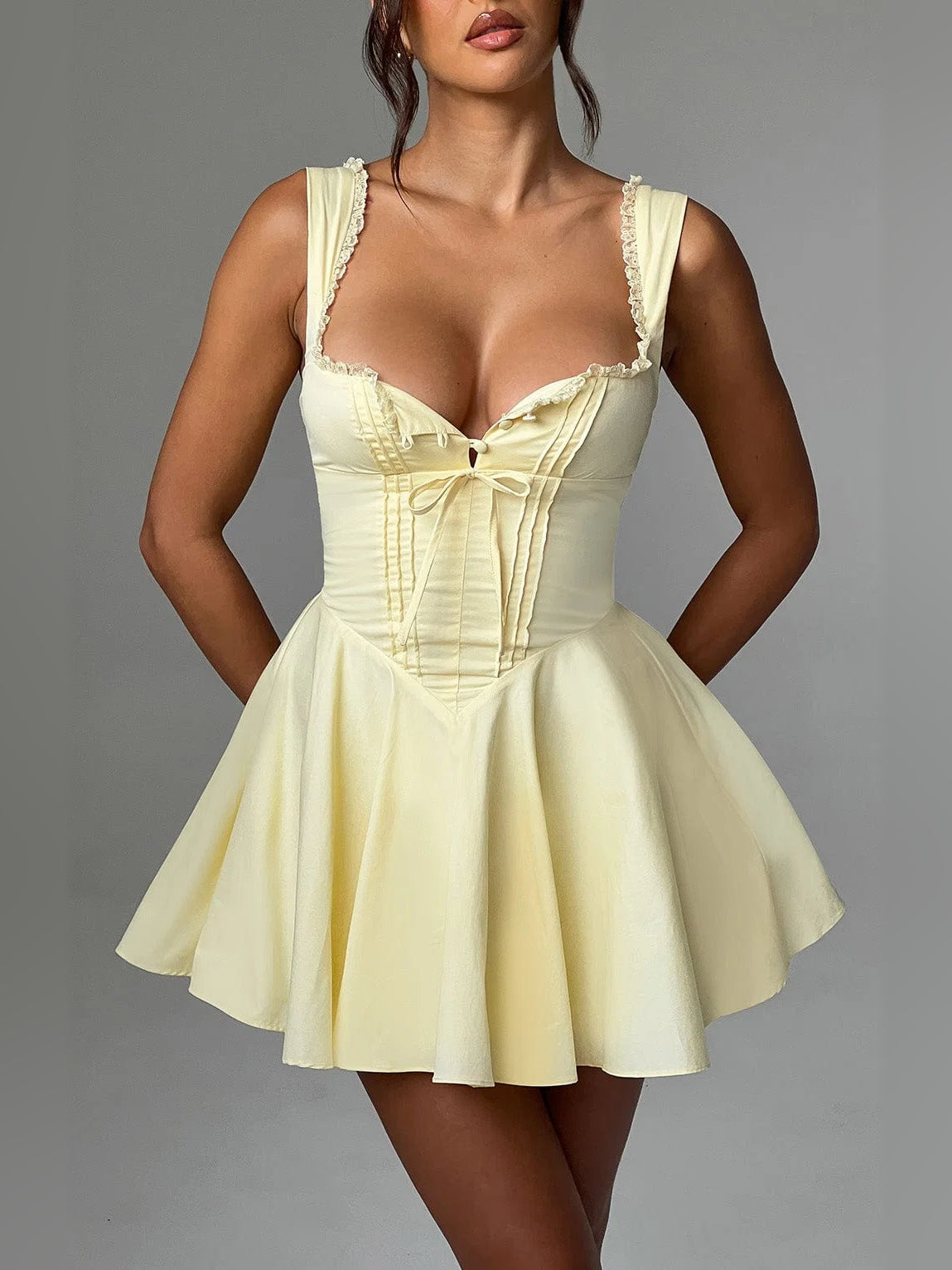 Lemon mini homecoming dress with lace-trim sweetheart neckline, bow front, and pleated skirt