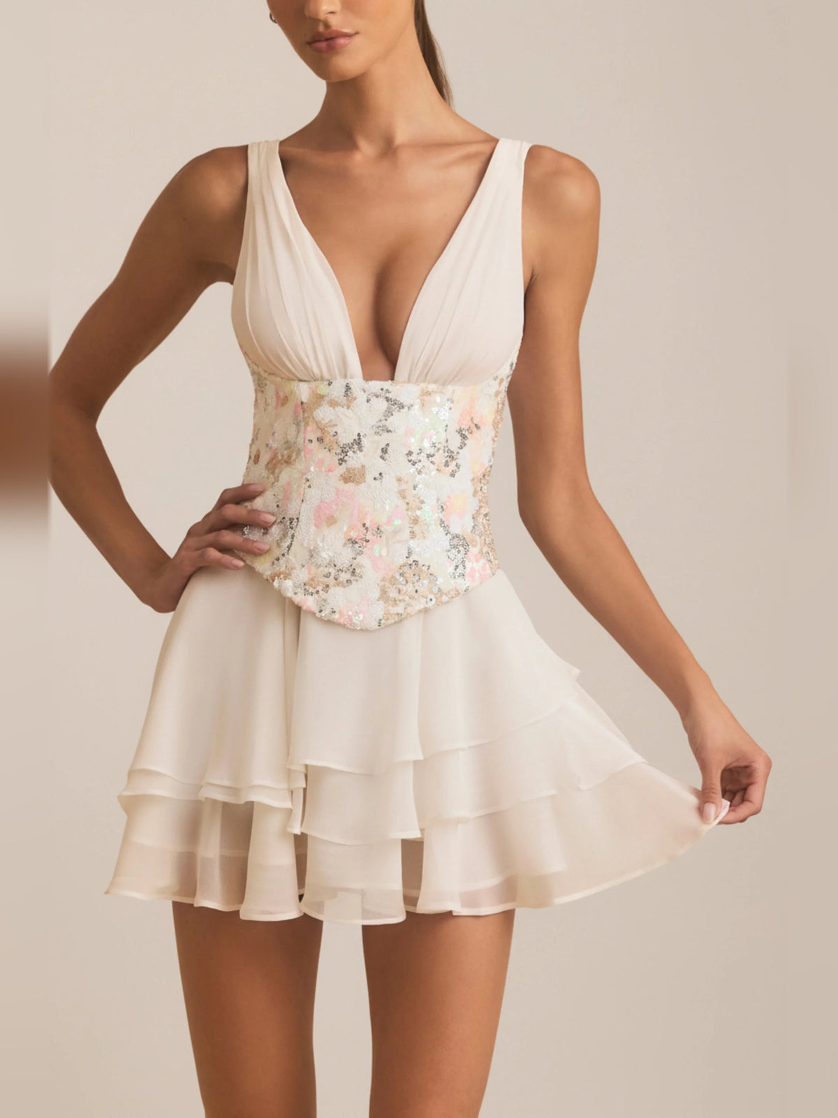 Ivory corset mini dress with deep V front, floral corset detailing, and tiered skirt