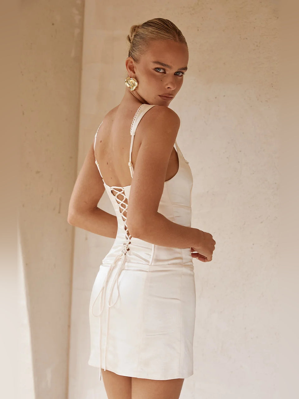 Ivory mini dress with lace-up open back and spaghetti straps