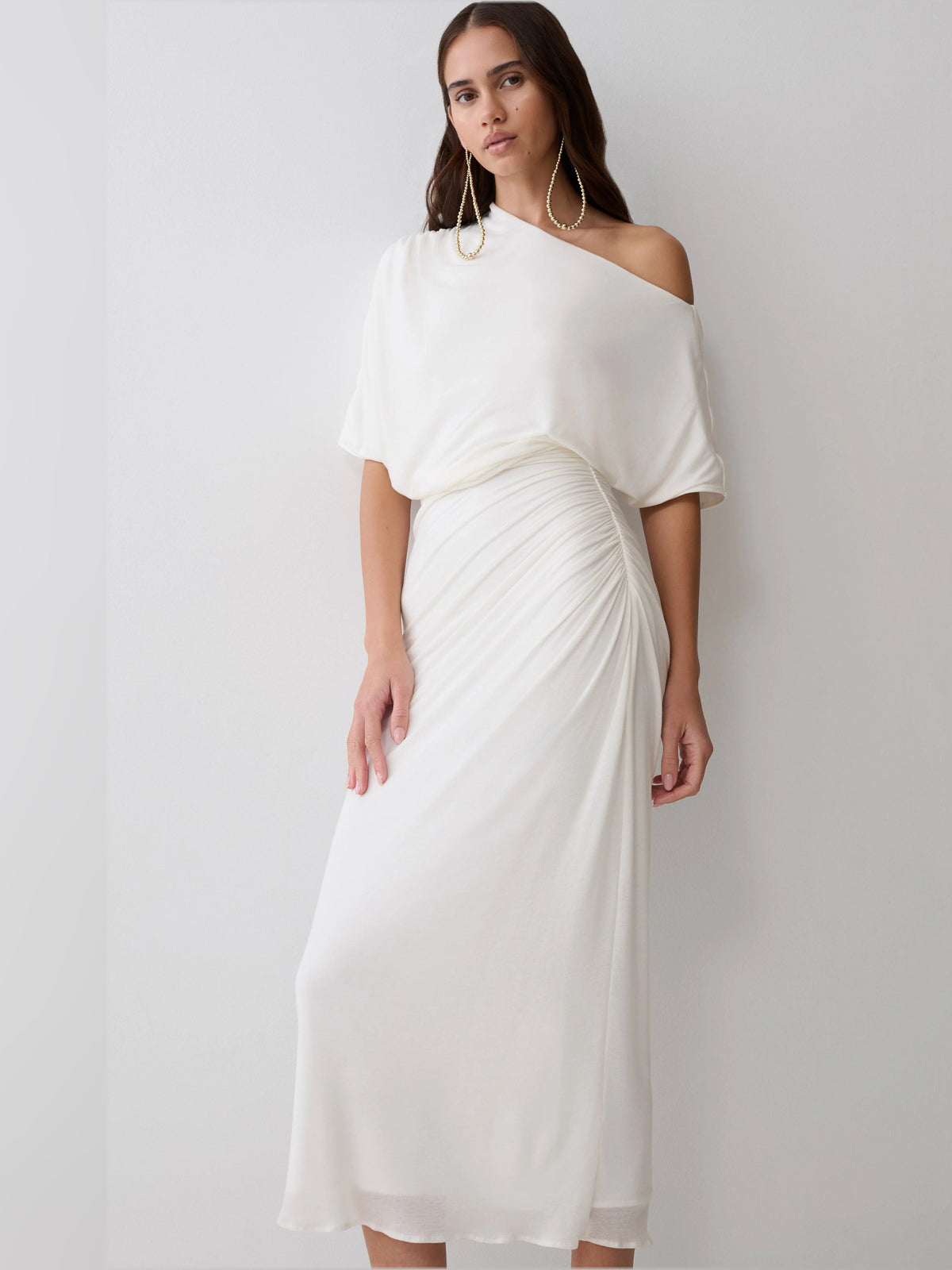 White one-shoulder midi dress with wrap-style drape at waist and short sleeves