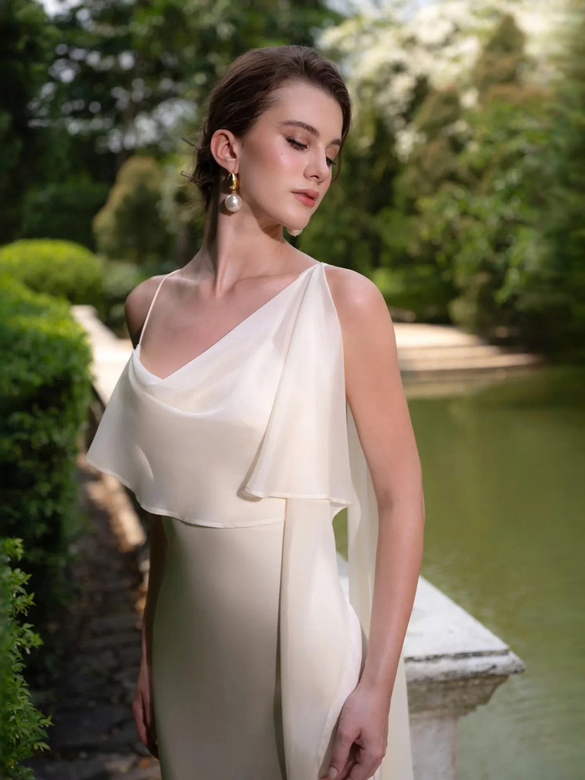 Ivory draped satin wedding dress with off-shoulder bodice and thin straps