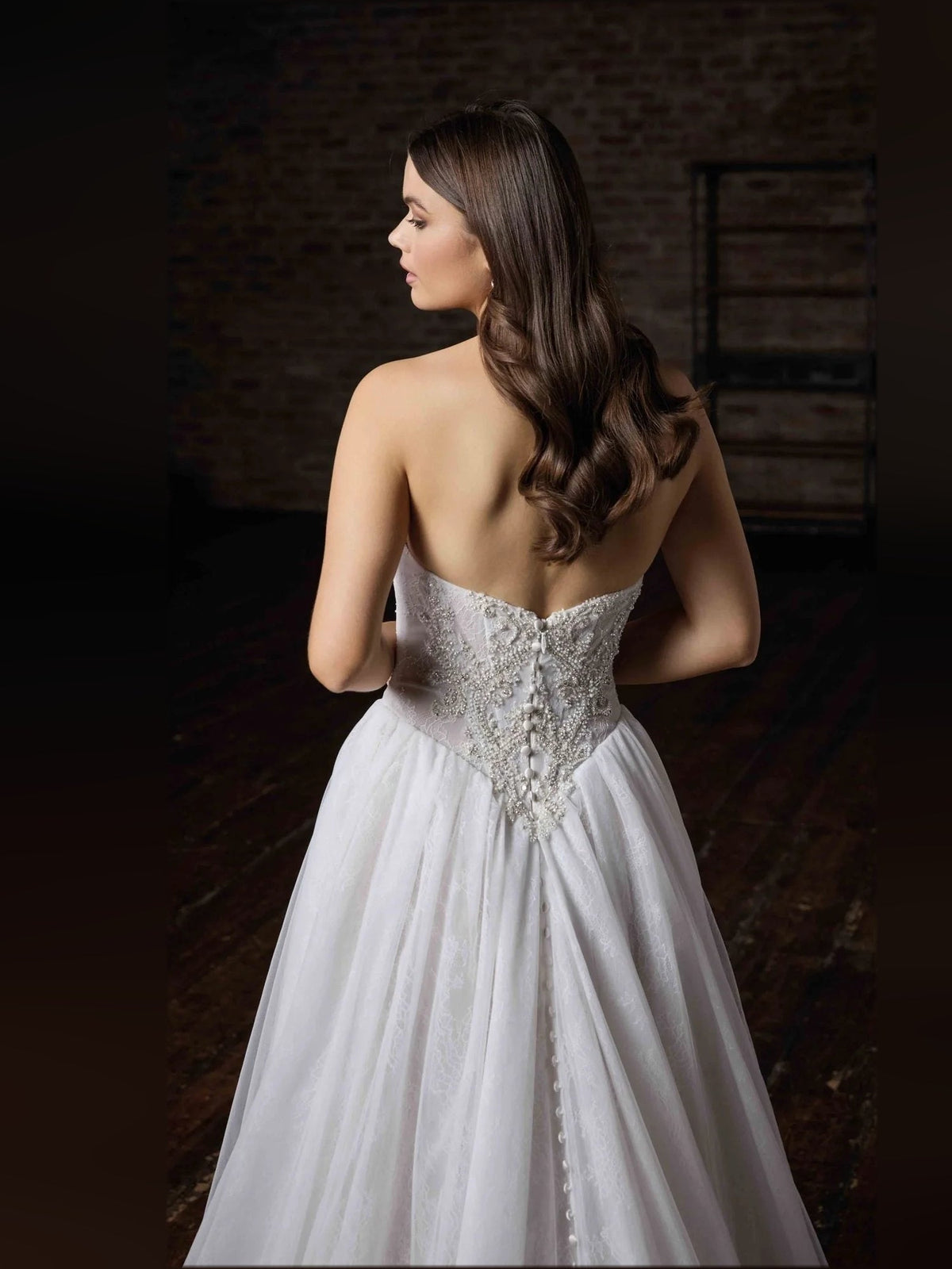 Ivory tulle A-line wedding dress with beaded corset bodice, open-back view