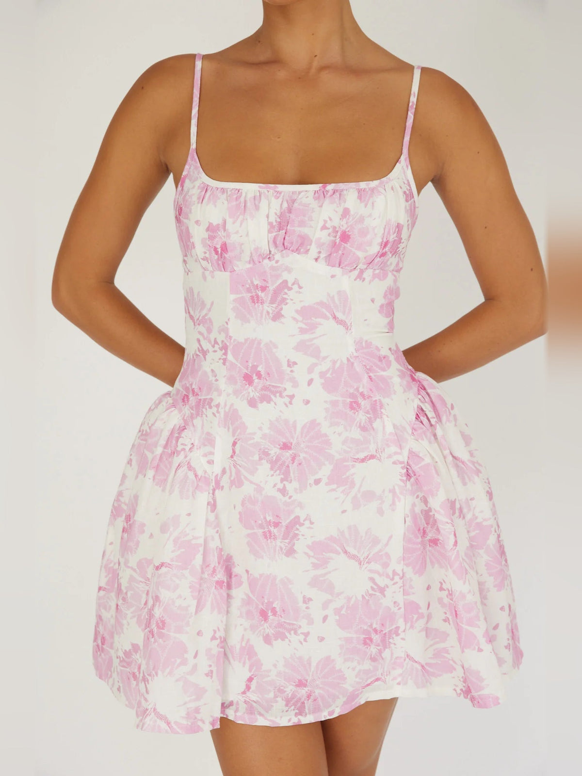Pink floral mini dress with square neckline, spaghetti straps, tiered skirt