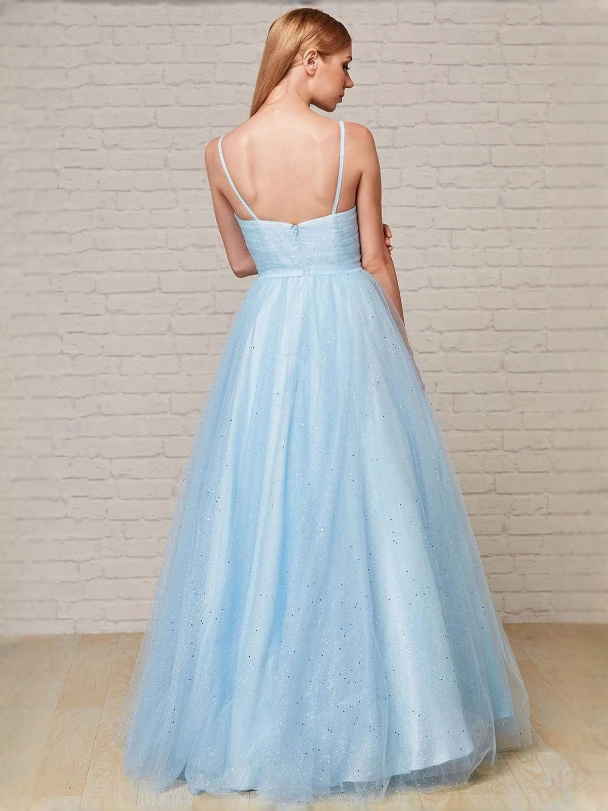Light blue glitter prom dress back view with thin straps and A-line tulle skirt