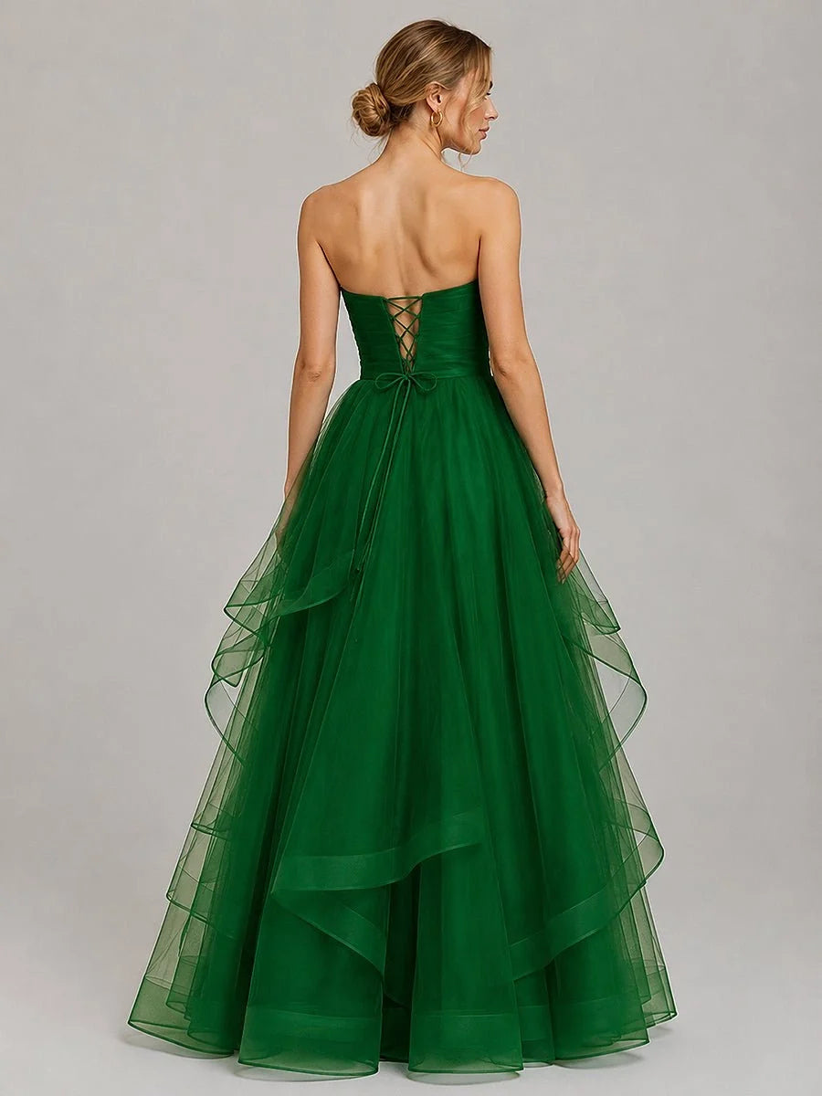 Emerald green strapless tulle prom dress with corset ruched back and full layered skirt