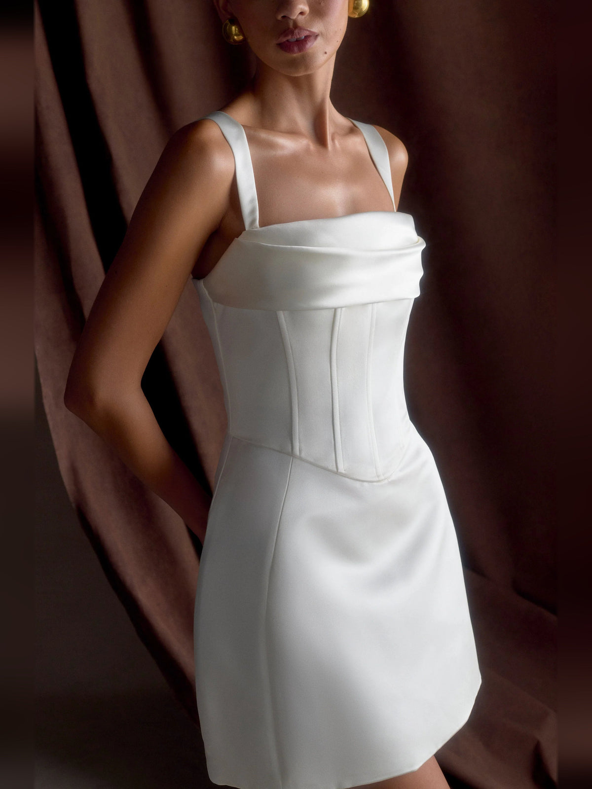 White satin corset mini dress with straight square neckline, front close pose