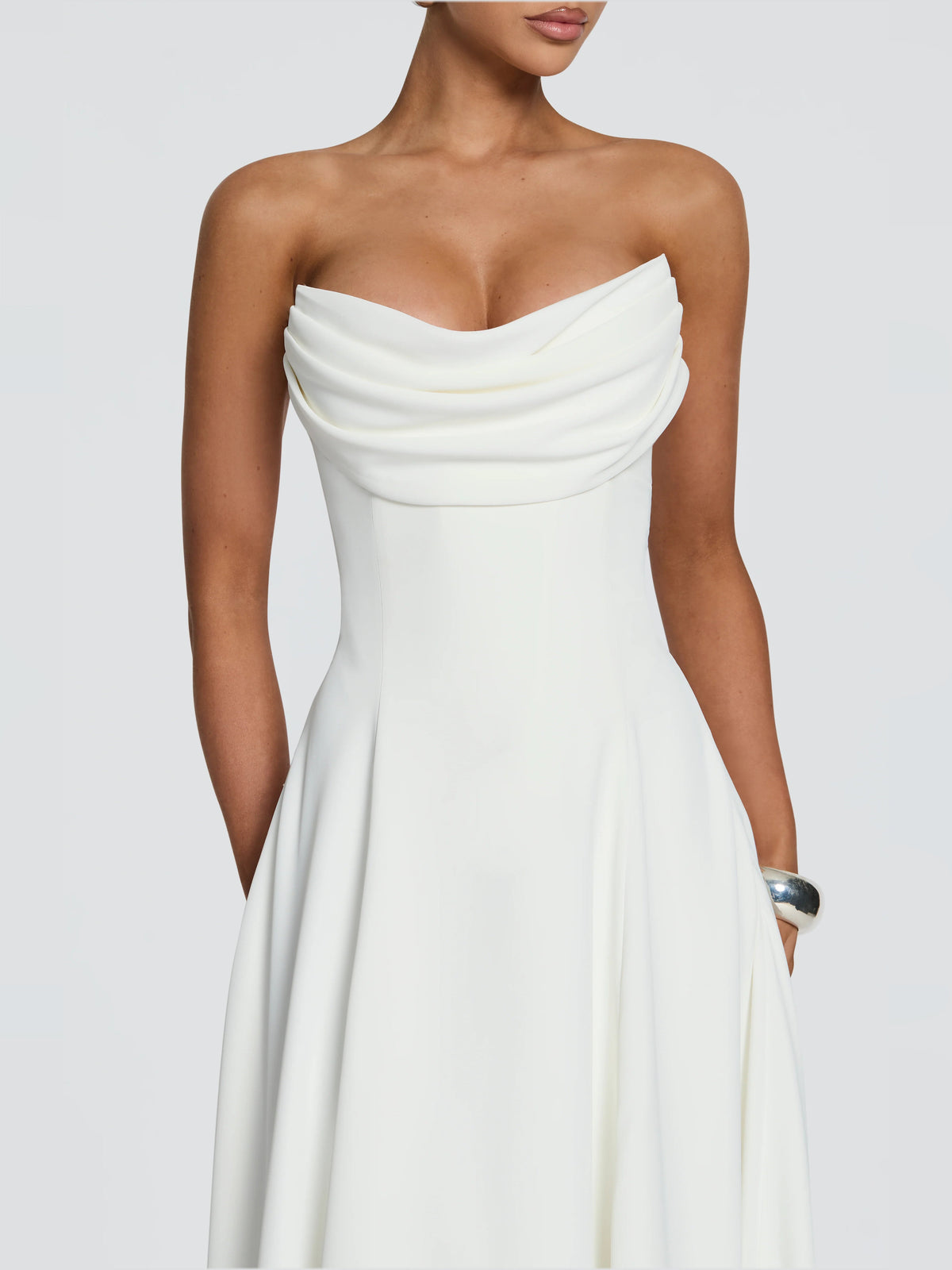 Ivory strapless midi dress close-up: draped neckline and fitted waist