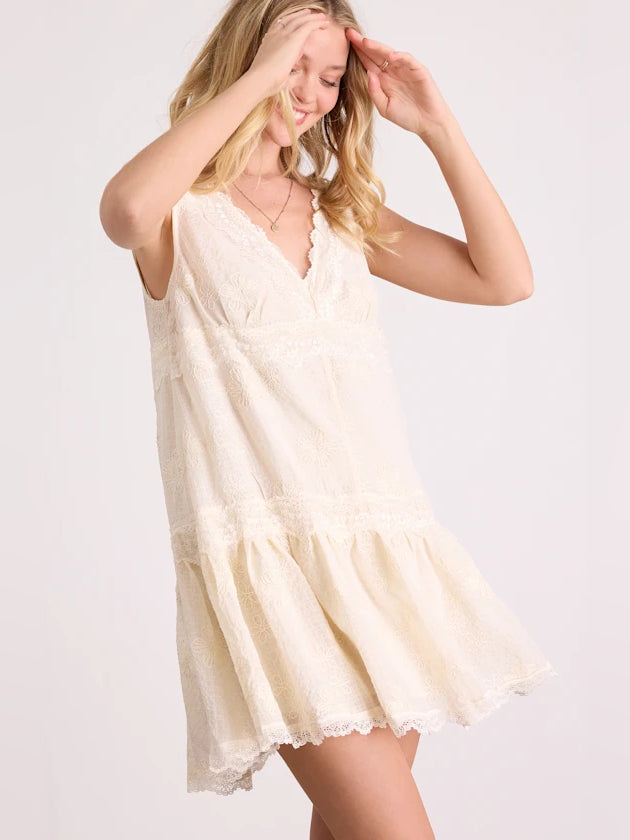 Cream sleeveless V-neck tiered mini dress with lace trim