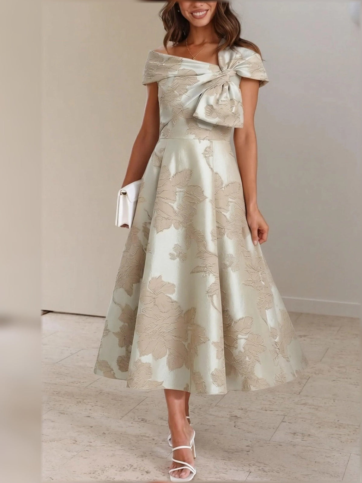 Champagne floral A-line tea-length dress with draped bow detail and cap sleeves