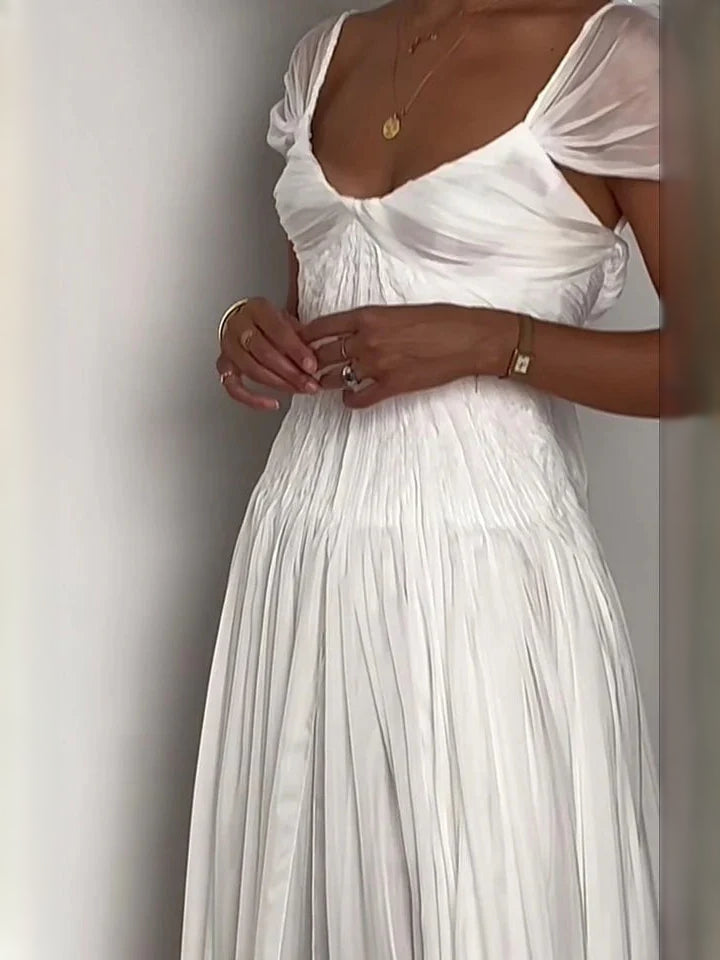 Ivory sweetheart wedding dress close-up: ruched bodice and draped neckline