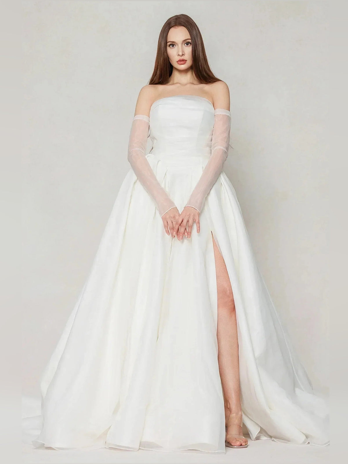 Ivory strapless wedding dress with fitted bodice, pleated skirt, and side slit