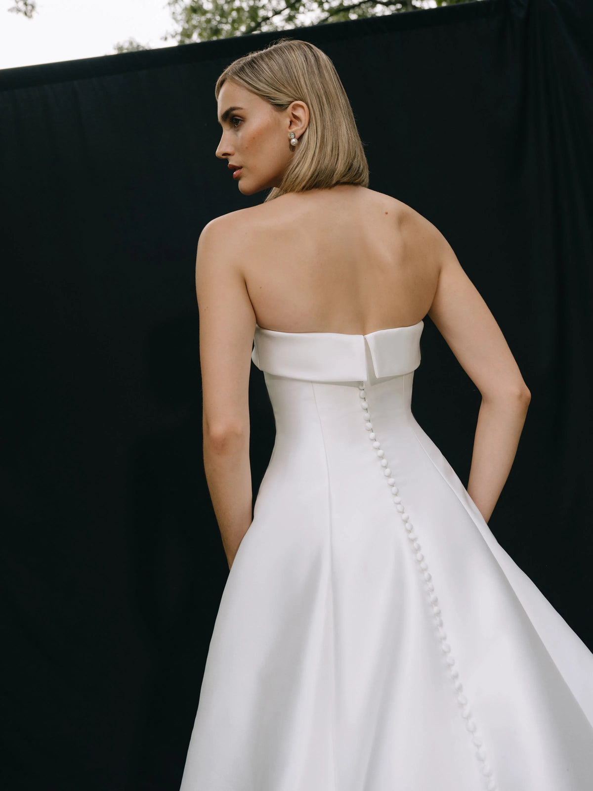 Ivory strapless A-line wedding dress with pearl-button back detail, satin