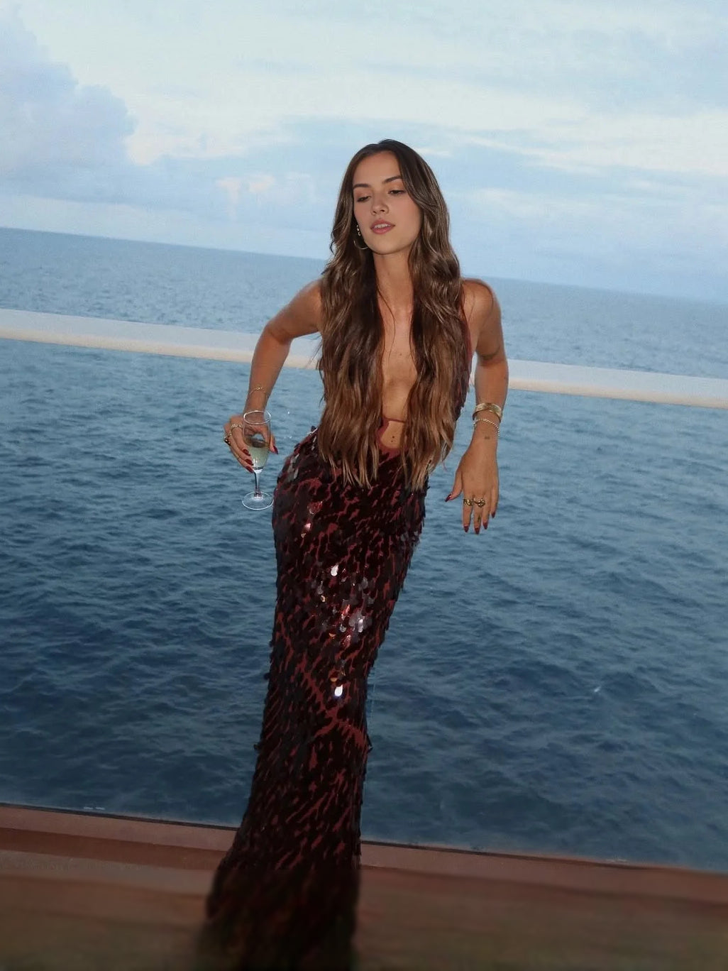 Burgundy sequin maxi dress with V-neck spaghetti straps and fitted floor length